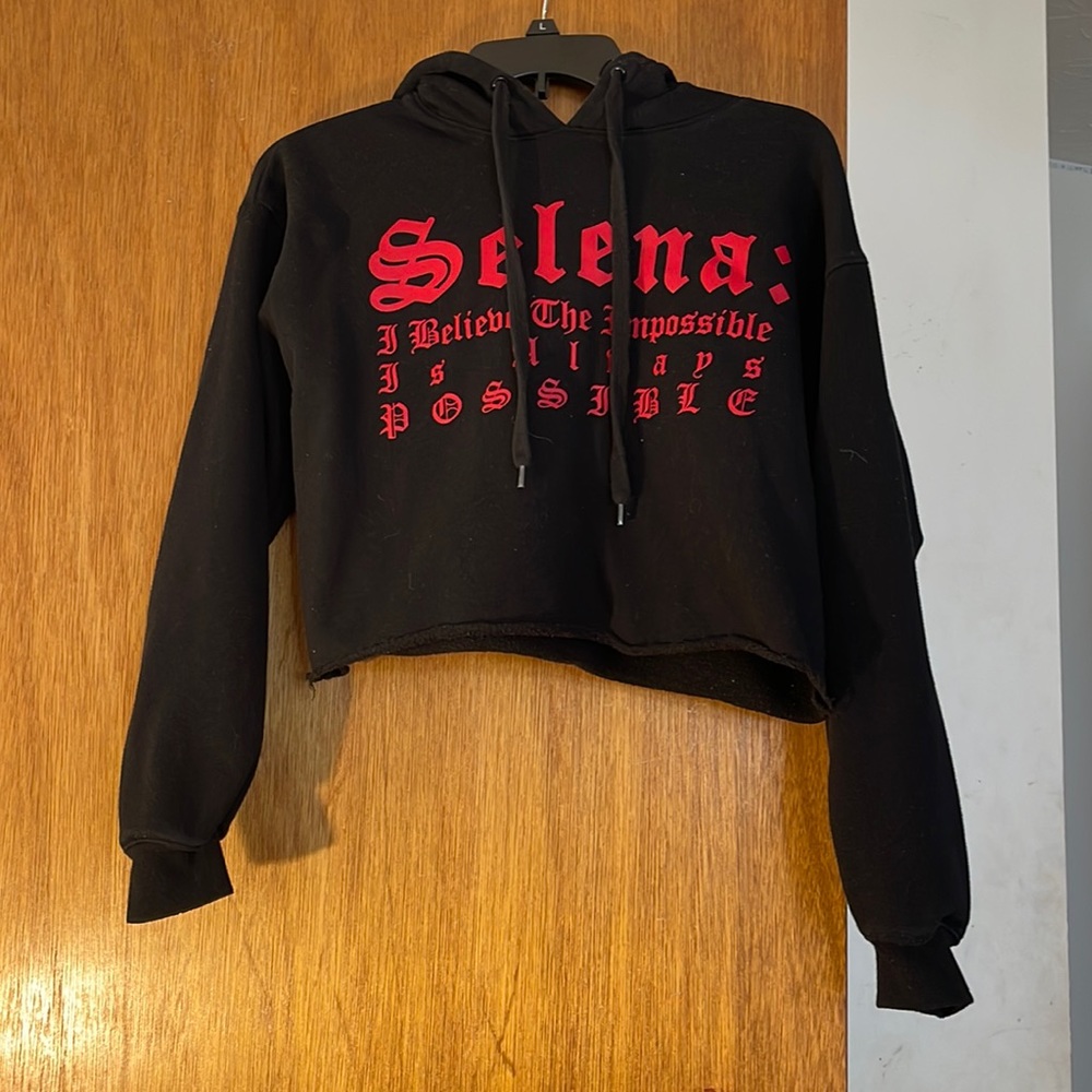 This is a black Selena crop top hoodie.